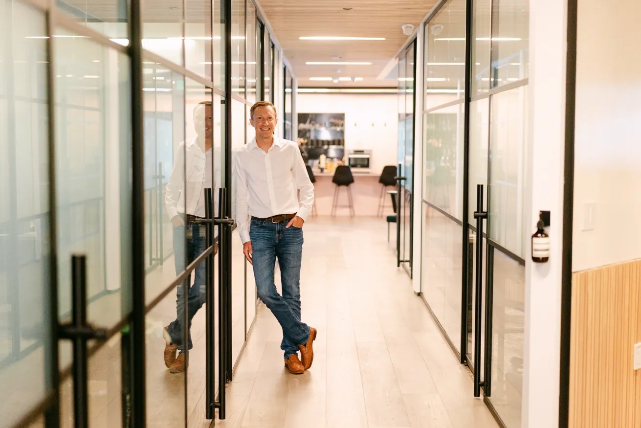 Paul Johnson in a modern office corridor